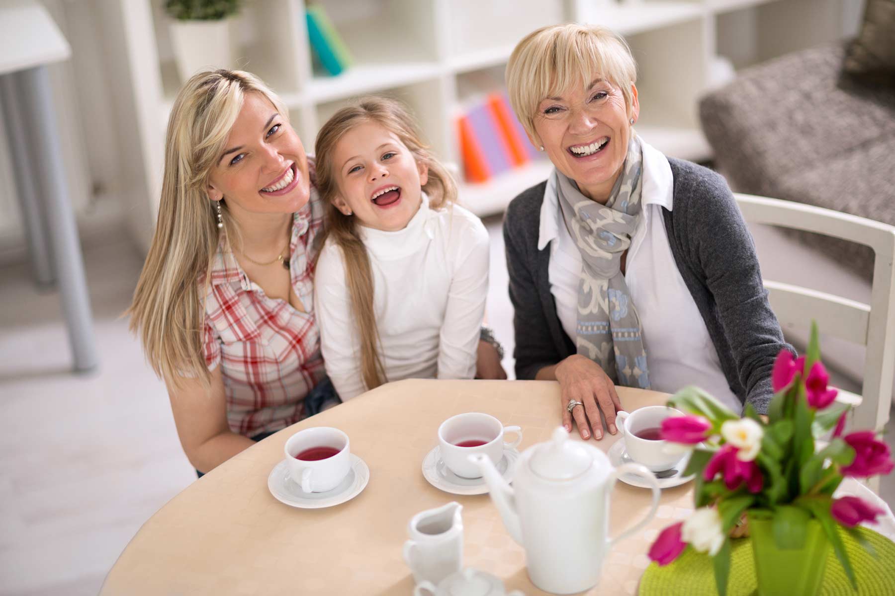 Grandmother having tea with daughter and granddaughter. 